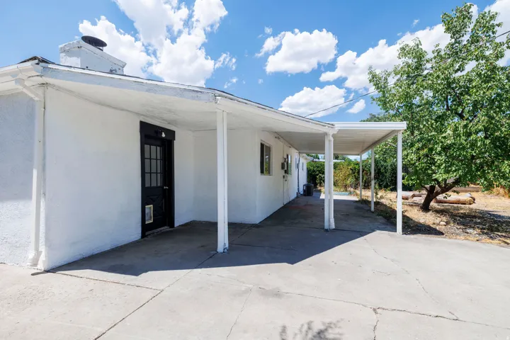 Covered patio area featuring a concrete surface and white support columns