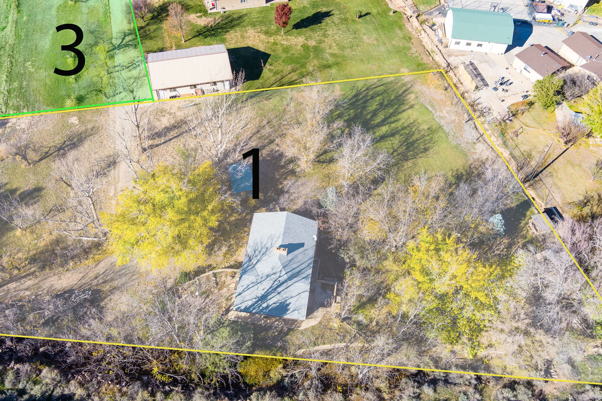 Expansive parcel featuring a single-family residence with a gray shingled roof, mature trees, and natural landscaping