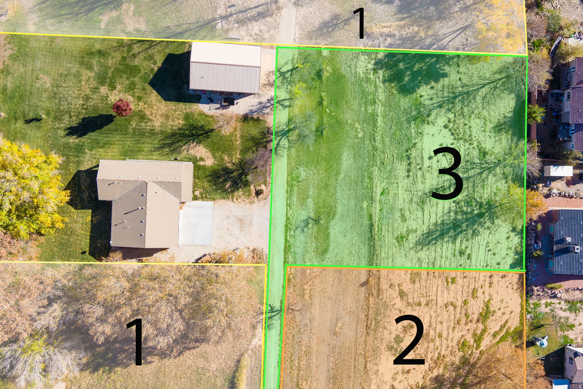 Aerial view of a property featuring a single-story residence with an attached garage and a detached outbuilding