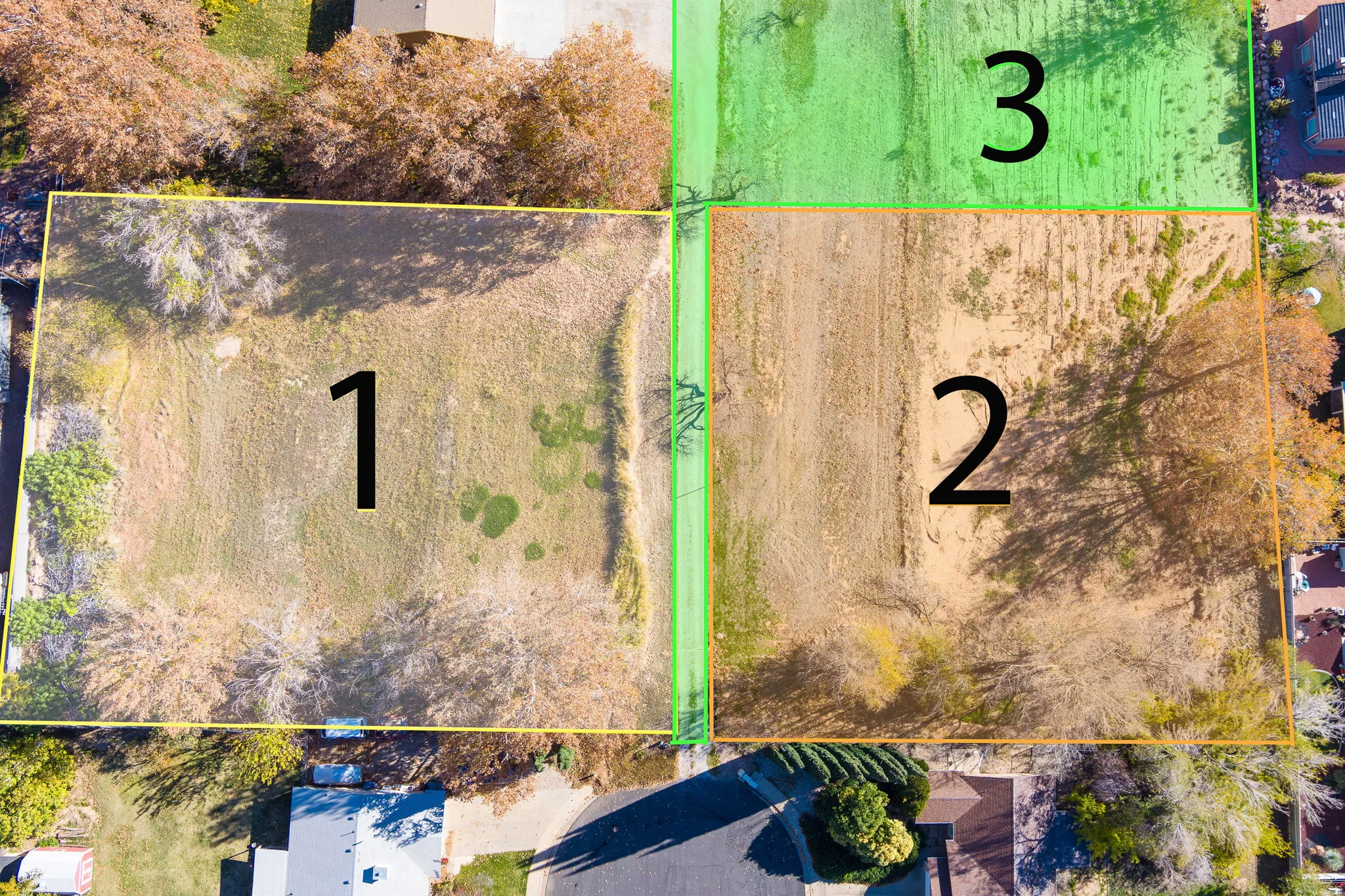 Aerial view showcasing three distinct parcels of land, bordered by mature trees and residential properties