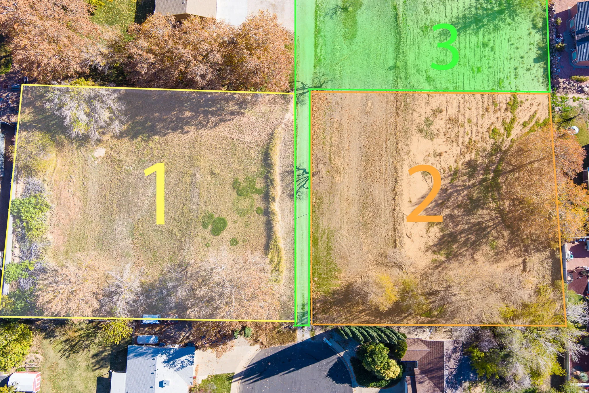 Aerial perspective showcasing two distinct plots of land, delineated by property lines, with surrounding residential structures and mature trees