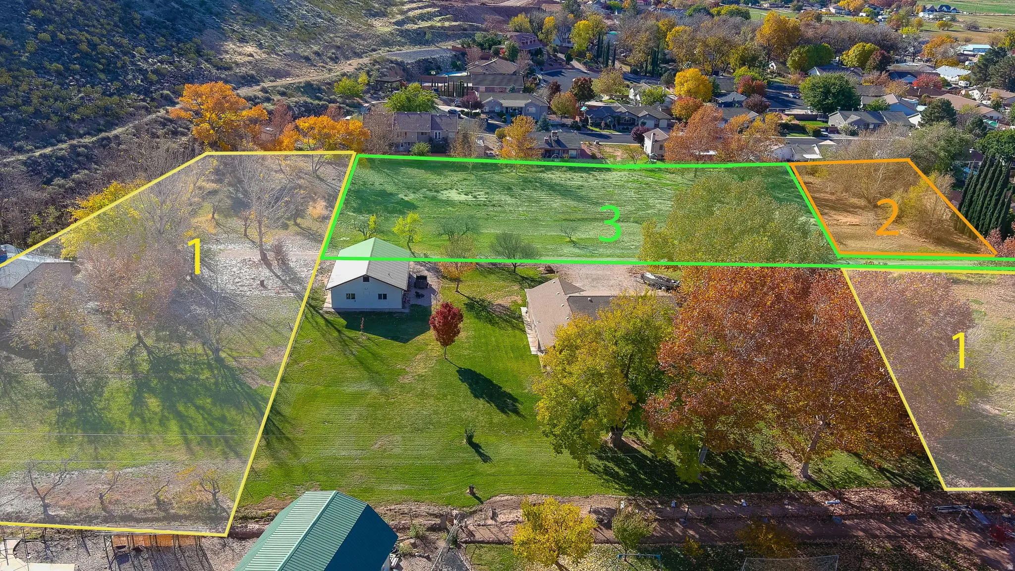 Expansive land parcels outlined in yellow and green, featuring mature trees and a gently sloping terrain