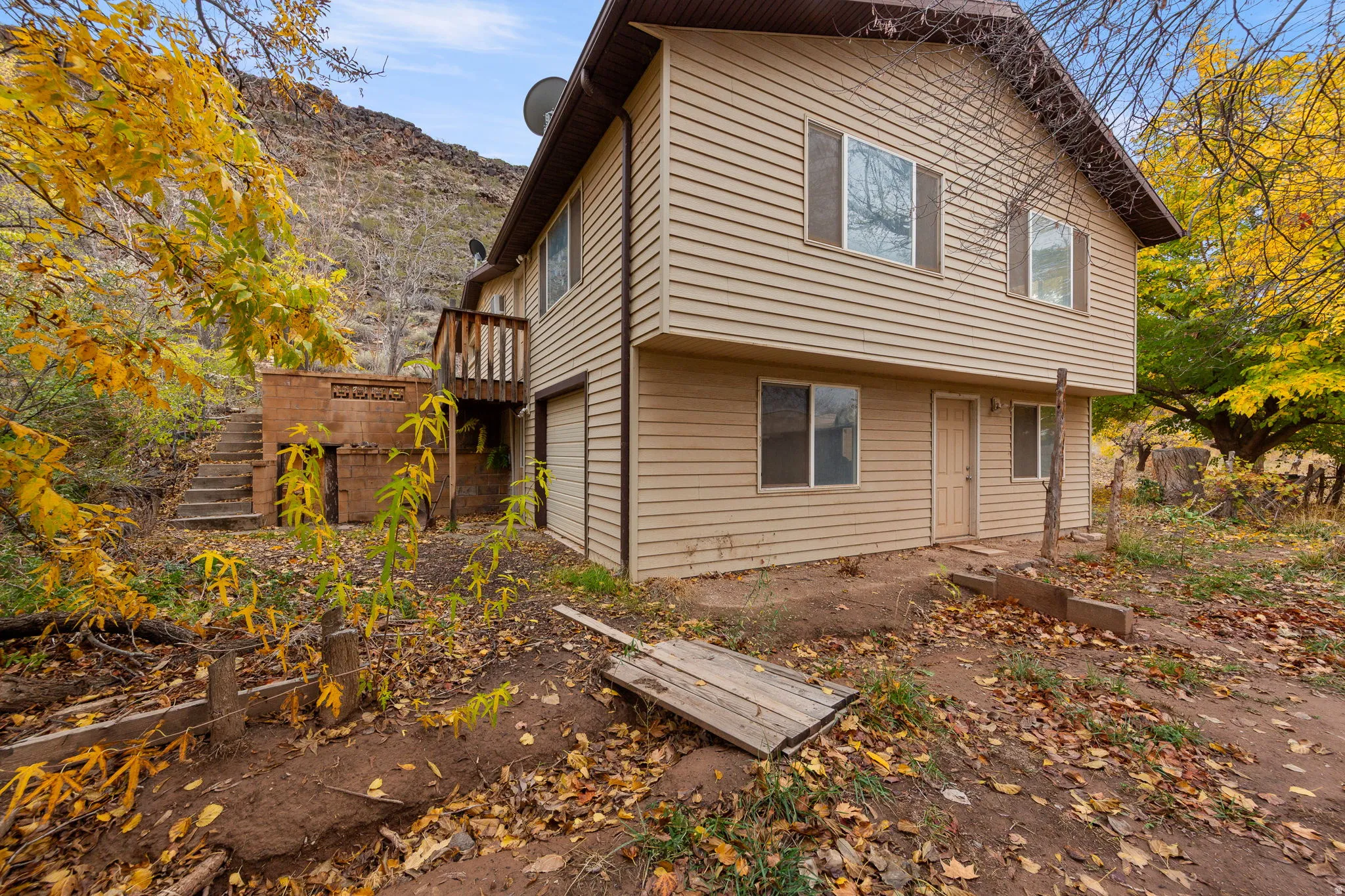 Two-story residence featuring horizontal siding, multiple windows, and a second-level balcony