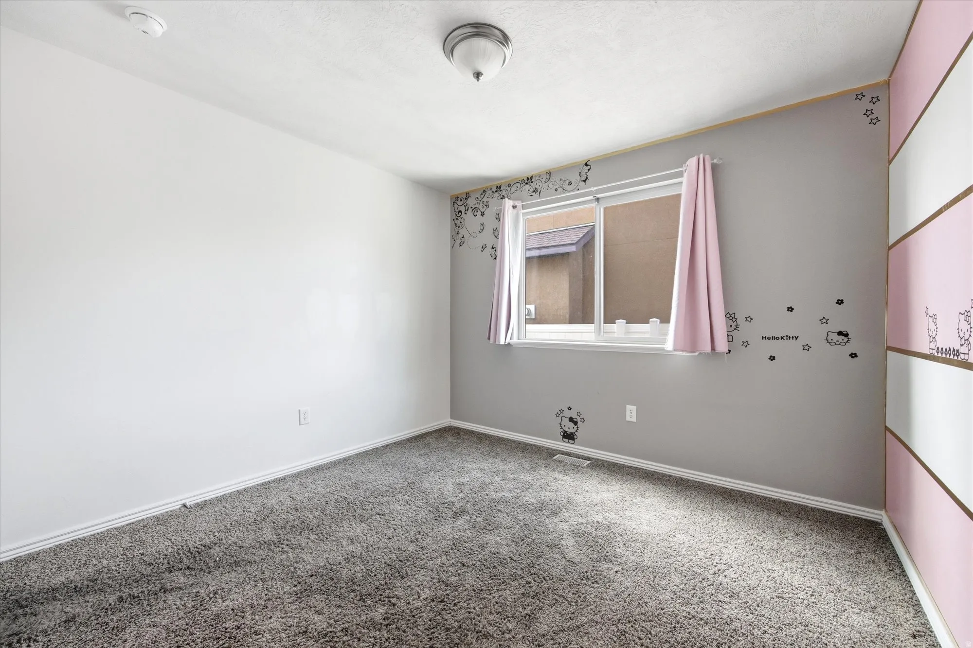 Interior room featuring gray carpet flooring and white baseboards