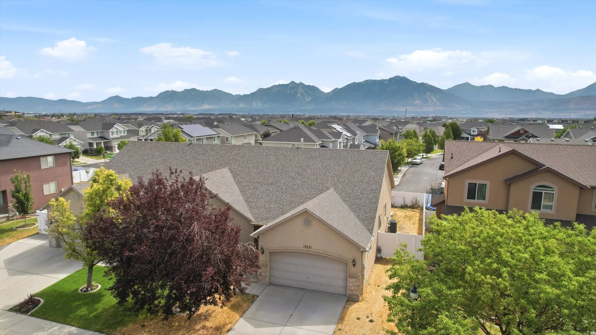 Single-story residence featuring an attached garage and a concrete driveway