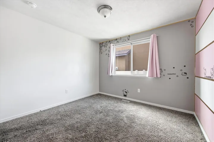 Interior room featuring gray carpet flooring and white baseboards