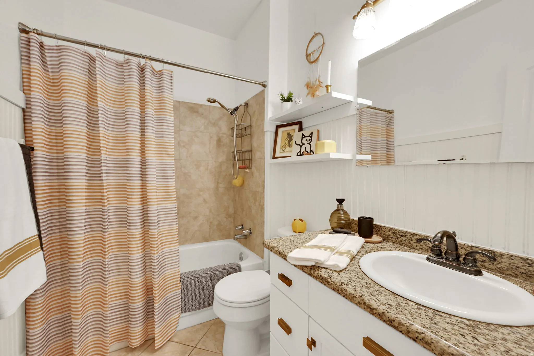 Bathroom featuring a vanity with a light-toned granite-style countertop