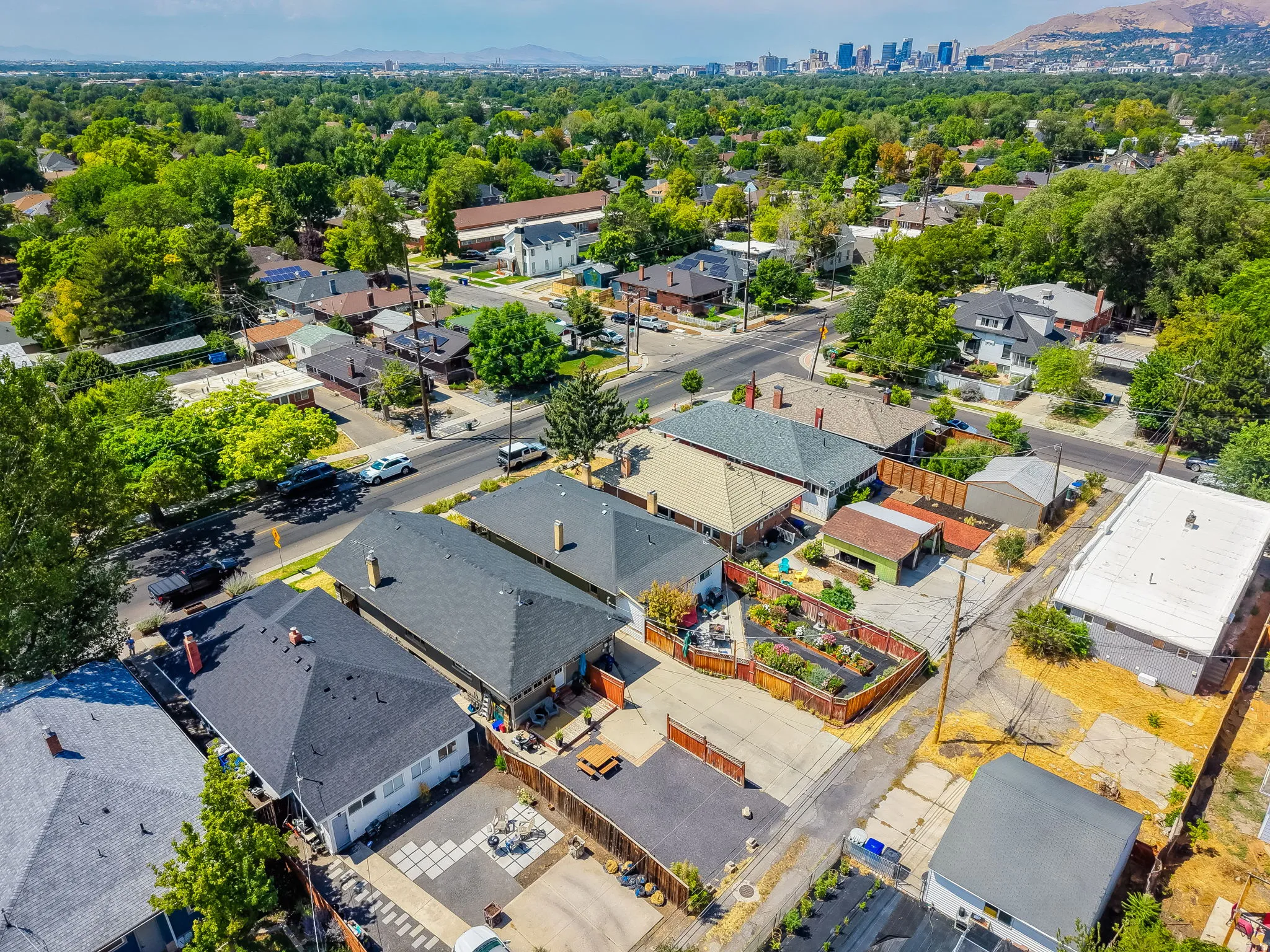 Aerial perspective showcasing a residential neighborhood with a distant cityscape and mountain backdrop