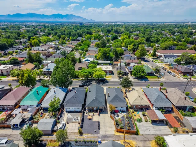 Aerial perspective showcasing a residential neighborhood with varied roofing styles and mature trees