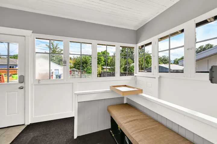 Enclosed porch featuring multiple large windows, a paneled ceiling