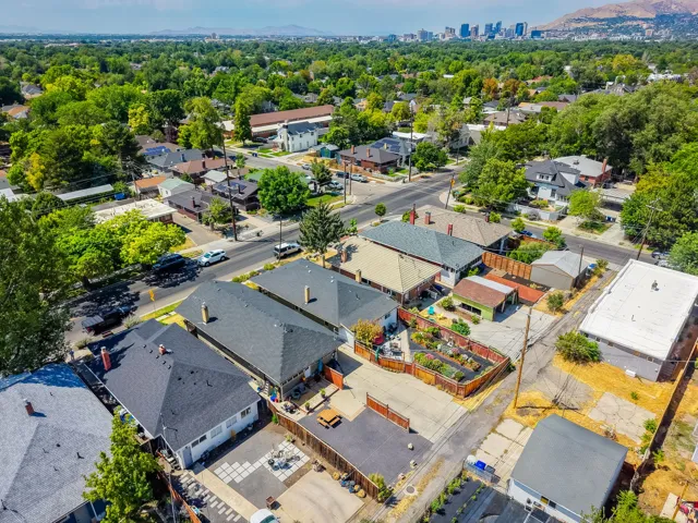 Aerial perspective showcasing a residential neighborhood with a distant cityscape and mountain backdrop