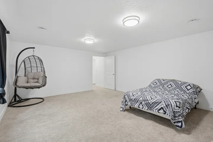 Spacious room featuring neutral carpeting and white walls