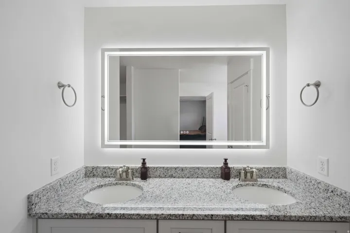 Dual vanity with undermount sinks, granite countertops, and brushed nickel faucets