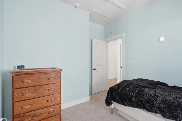 Light blue walls with white trim and carpeting