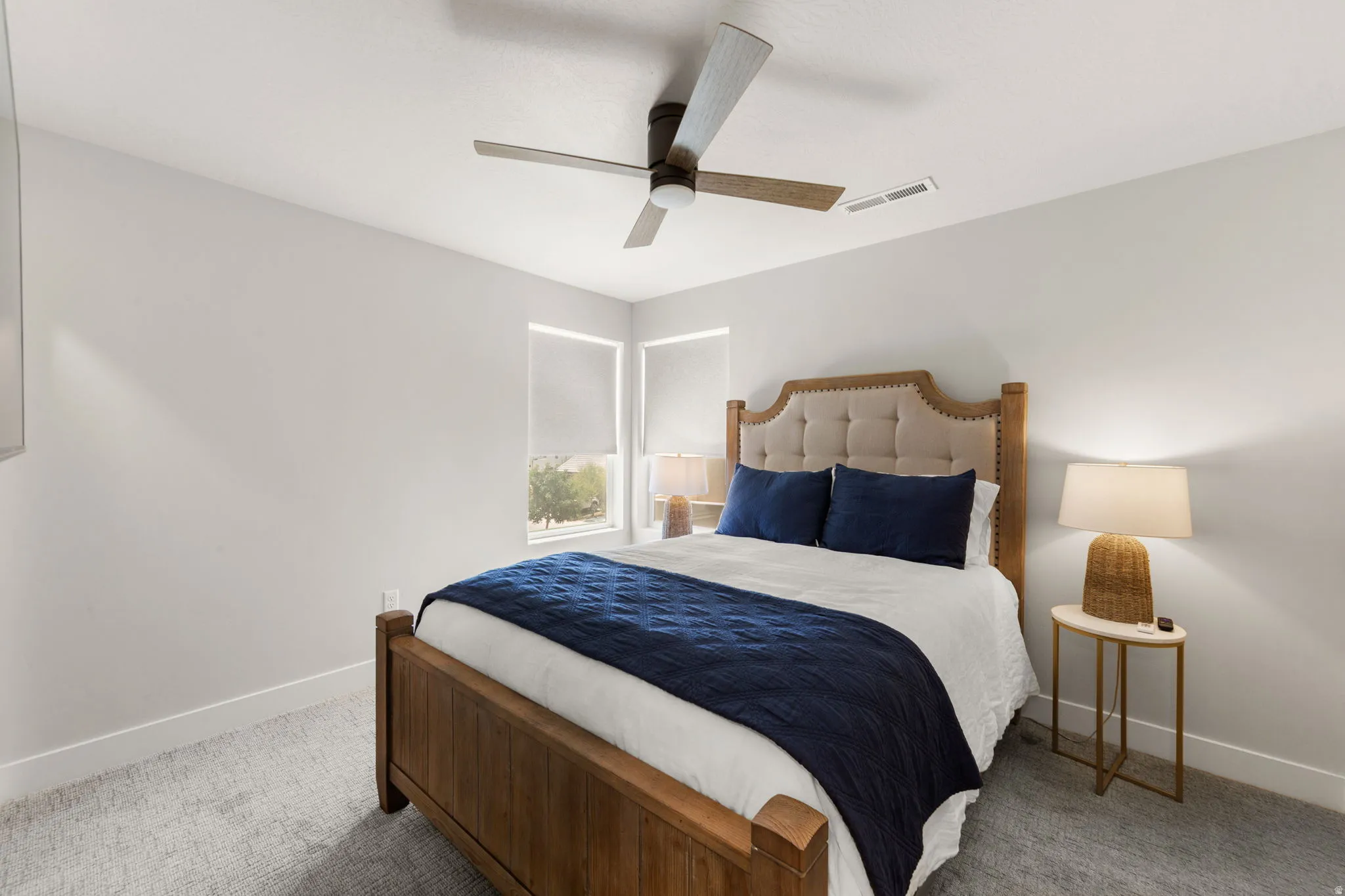 Neutral wall colors complement the light gray carpet flooring