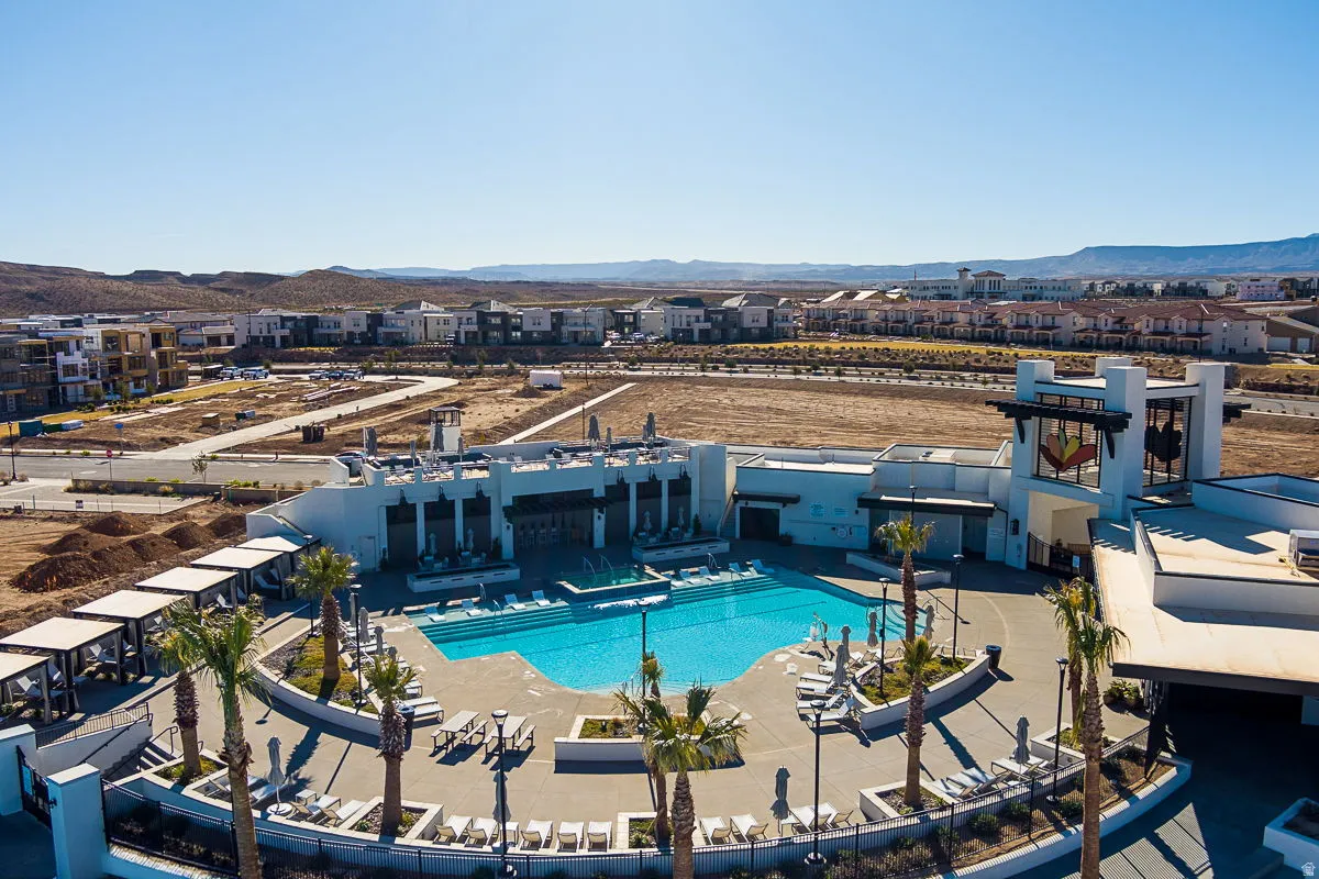 Resort-style pool with integrated lounging areas and surrounding cabanas