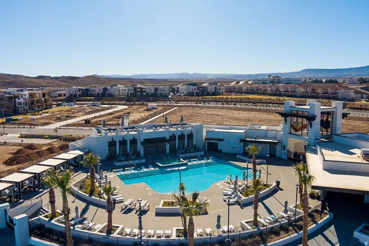 Resort-style pool with integrated lounging areas and surrounding cabanas