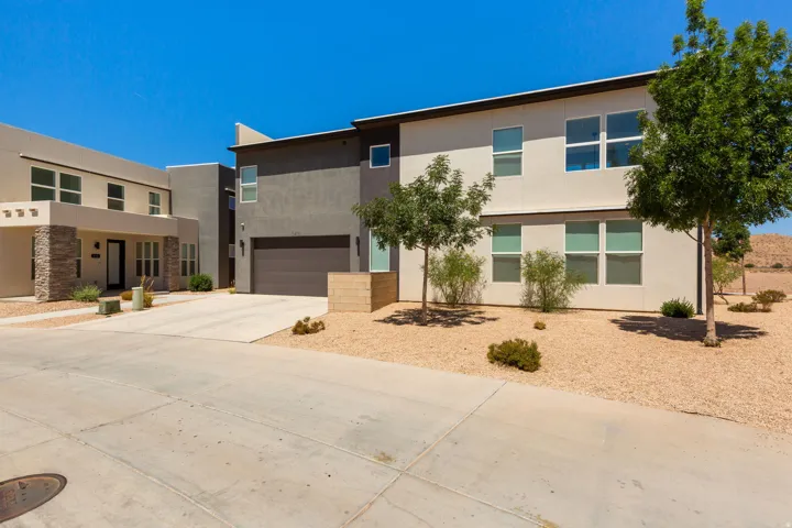 Modern exterior with a neutral stucco finish and stone accents