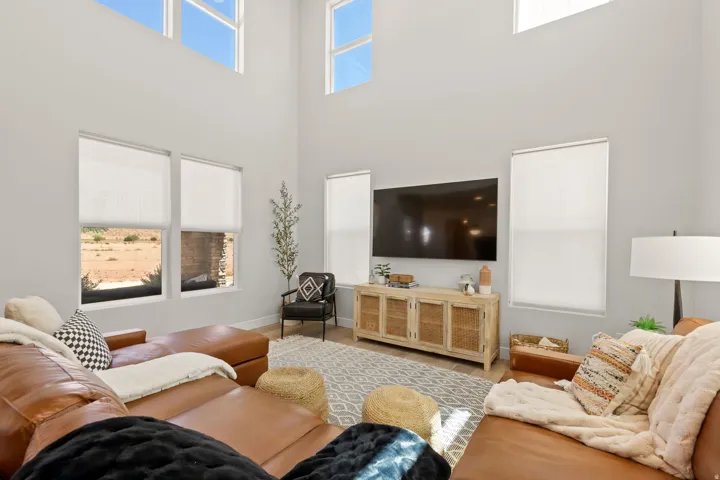 Vaulted ceiling living area featuring light wood-finish flooring