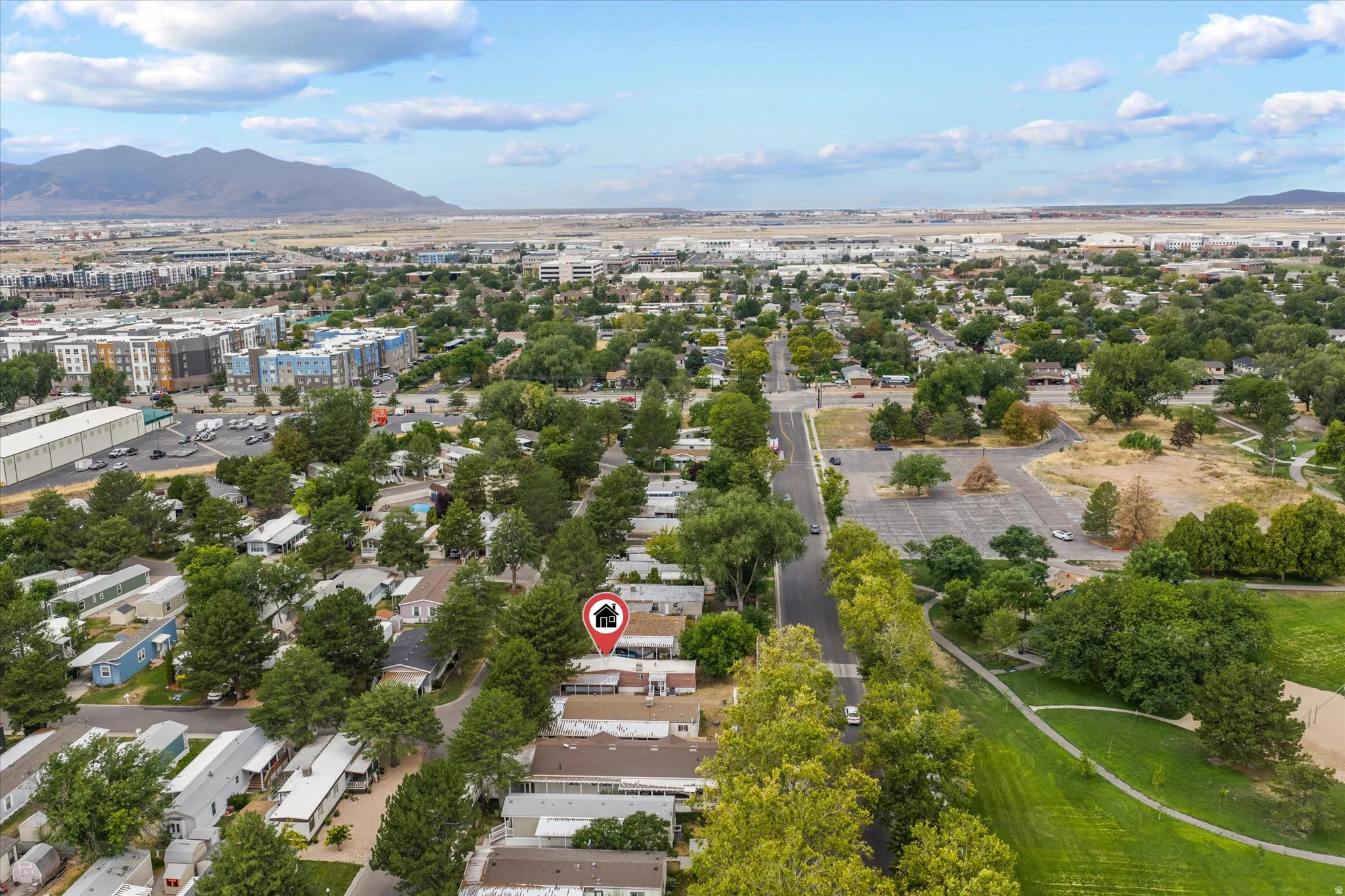 Aerial perspective of a neighborhood with residential structures and mature trees