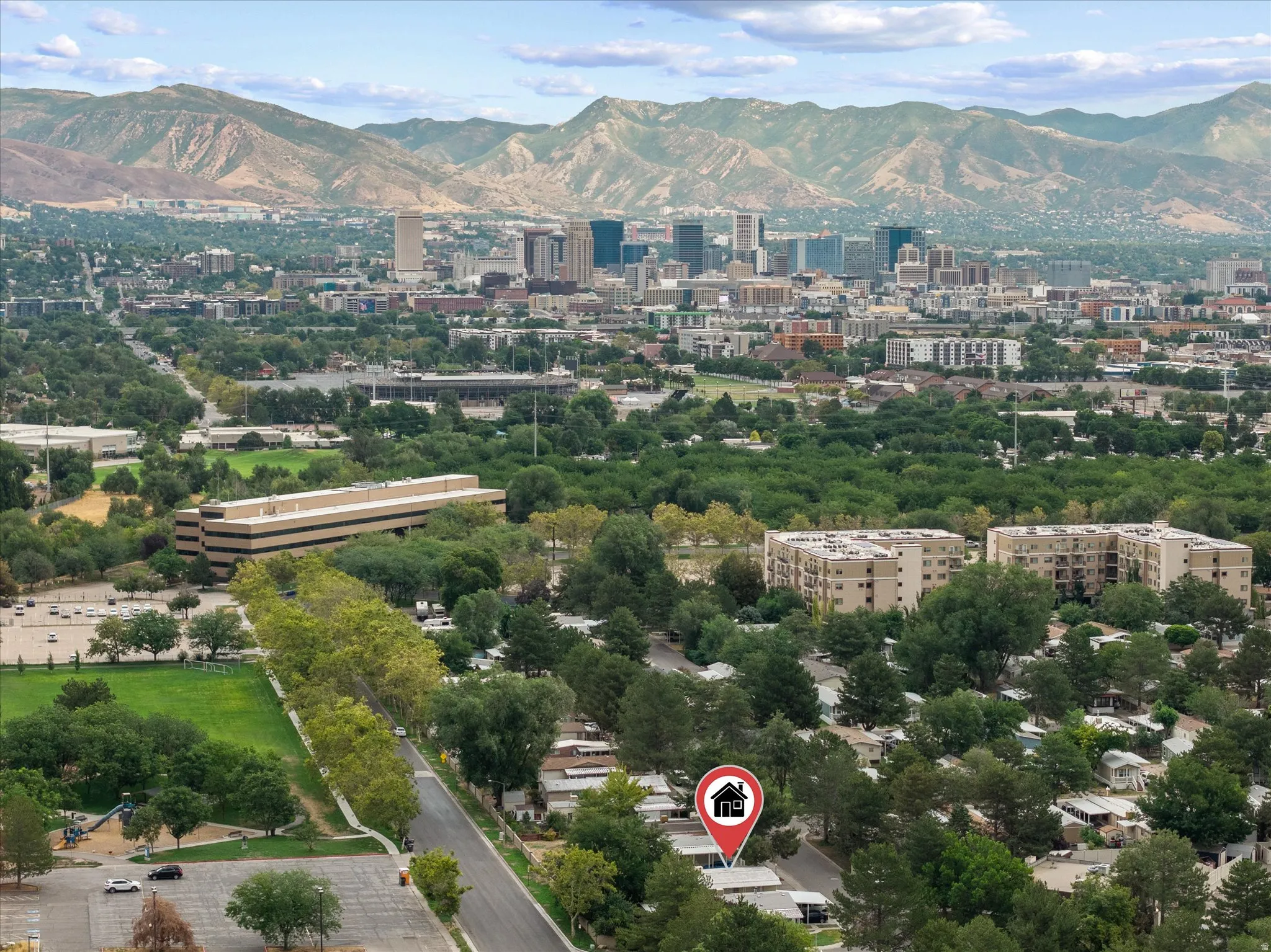 Elevated aerial perspective showcasing the property's setting amidst a residential area with mature trees