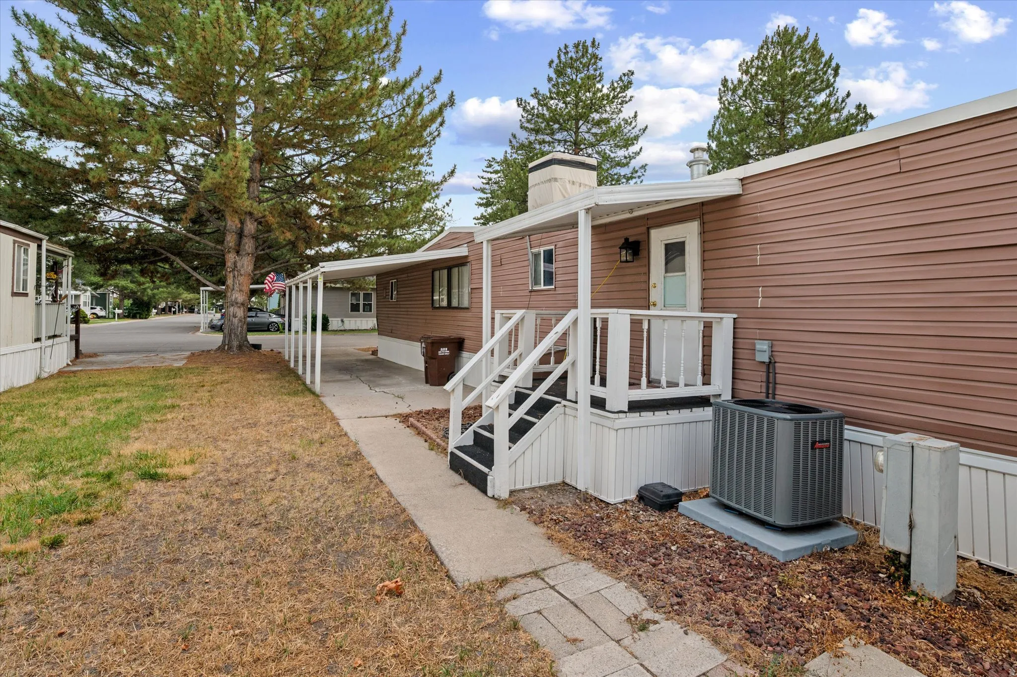 Brown siding exterior with white trim and a covered porch