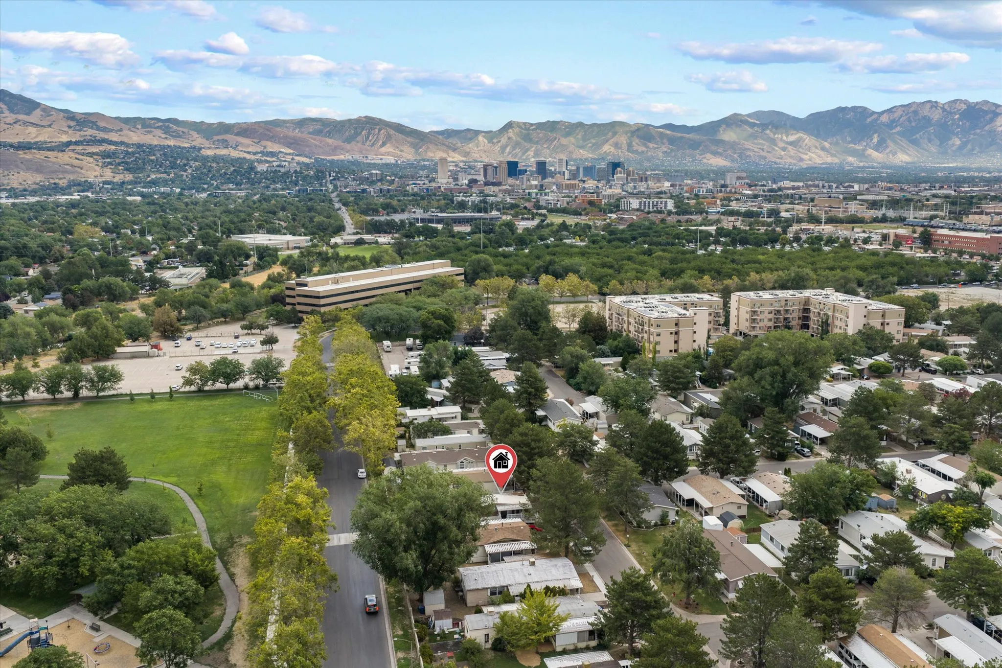 Aerial perspective showcasing a residential area with varied housing structures and mature trees