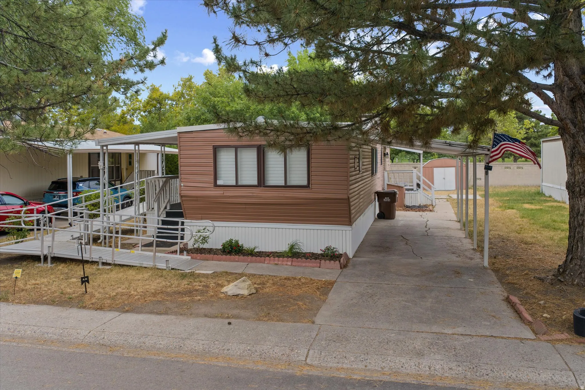 Manufactured home featuring brown horizontal siding and white trim