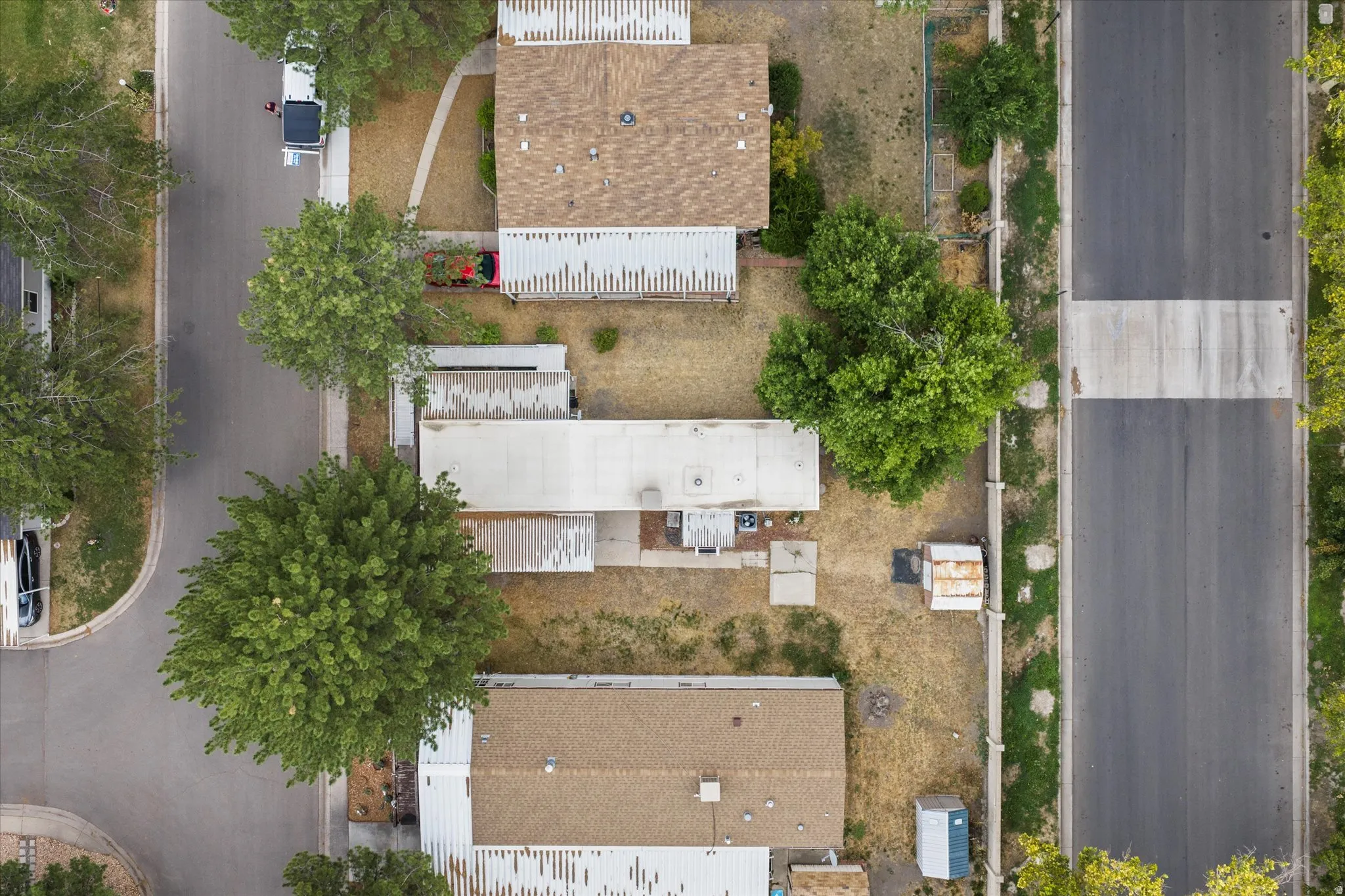 Aerial perspective showcasing multiple properties along a paved street