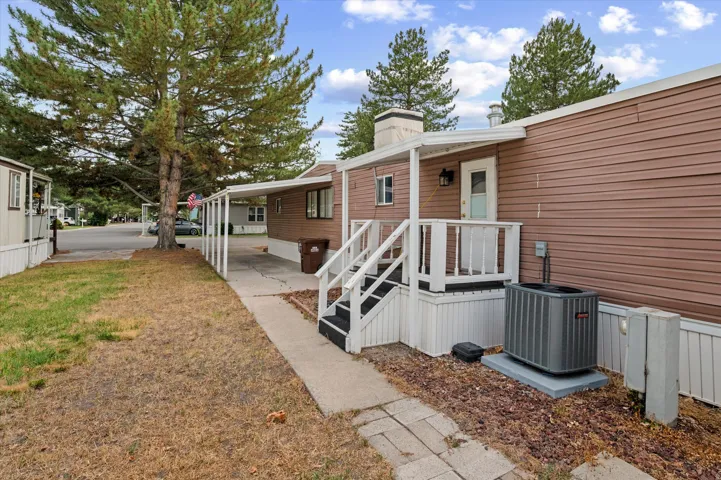 Brown siding exterior with white trim and a covered porch