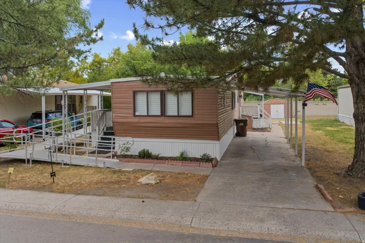Manufactured home featuring brown horizontal siding and white trim