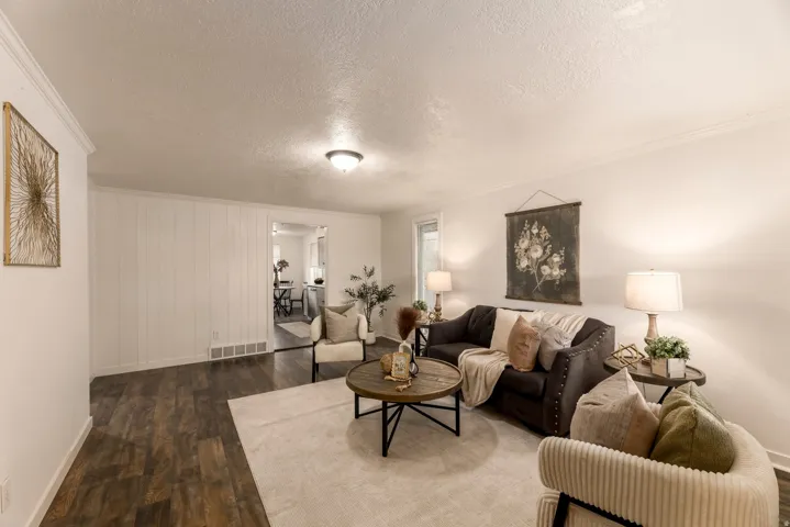 Living area featuring wood-finish flooring, white walls, and a recessed ceiling light