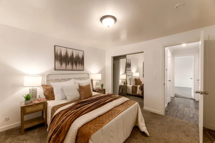 Carpeted bedroom featuring white walls and a ceiling-mounted light fixture