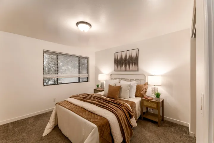 Bedroom featuring carpet flooring, a large window with blinds, and recessed lighting