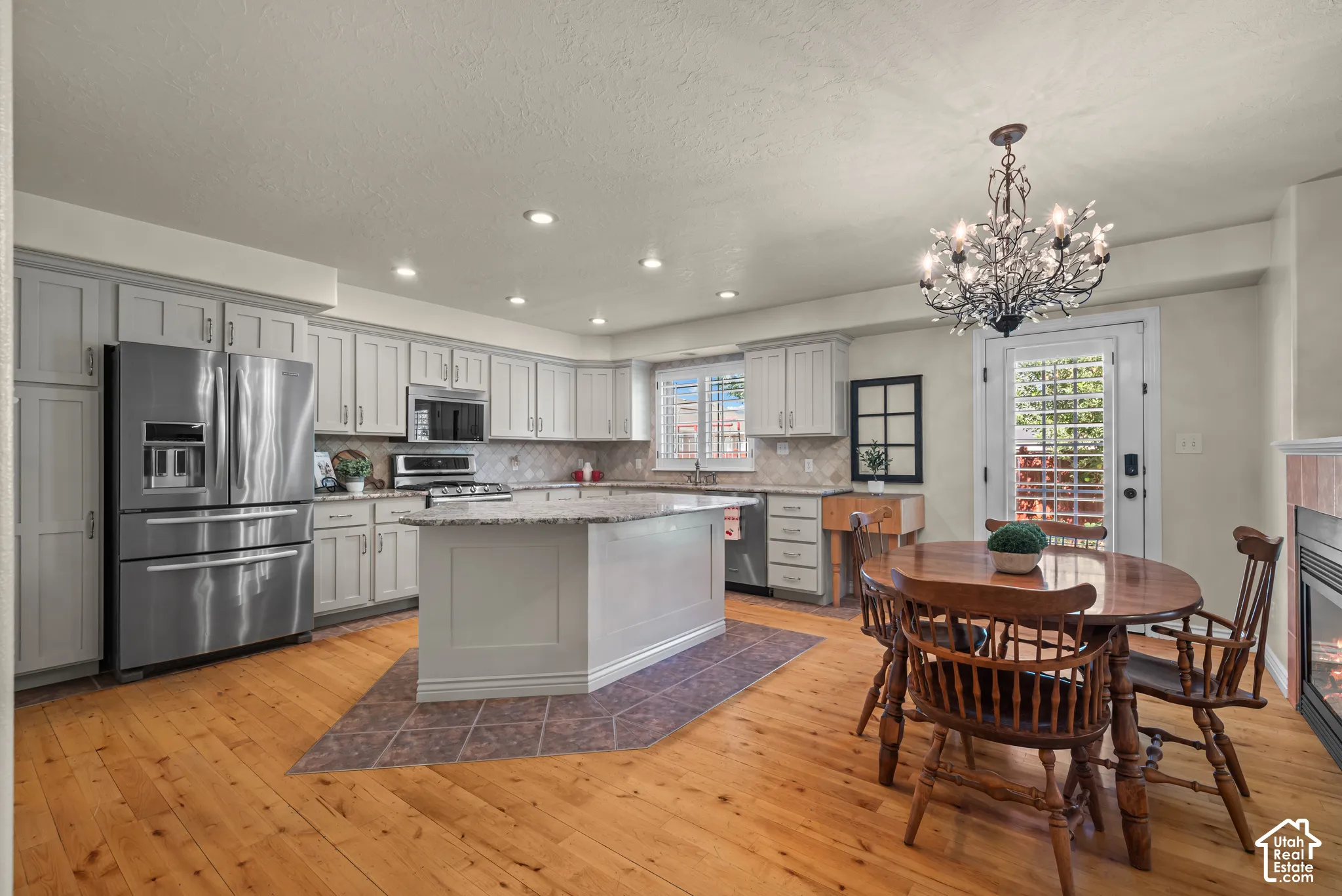 remodeled kitchen with grey shaker style cabinets and granite countertops