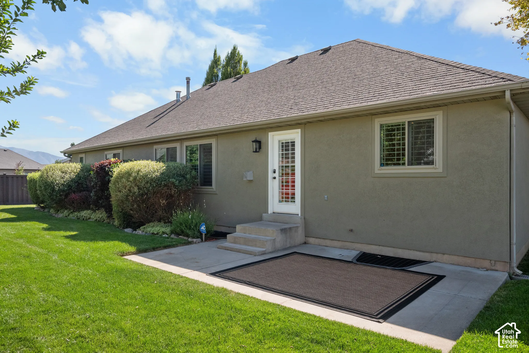 View of rear of home with large concrete patio
