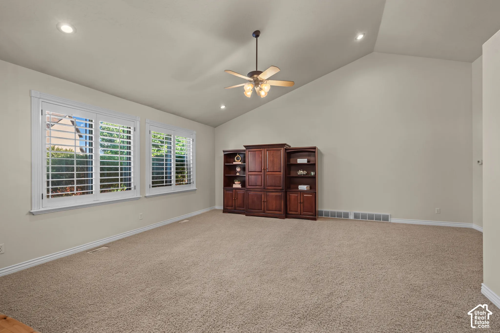 great room with vaulted ceiling, recessed lighting and plantation shutters