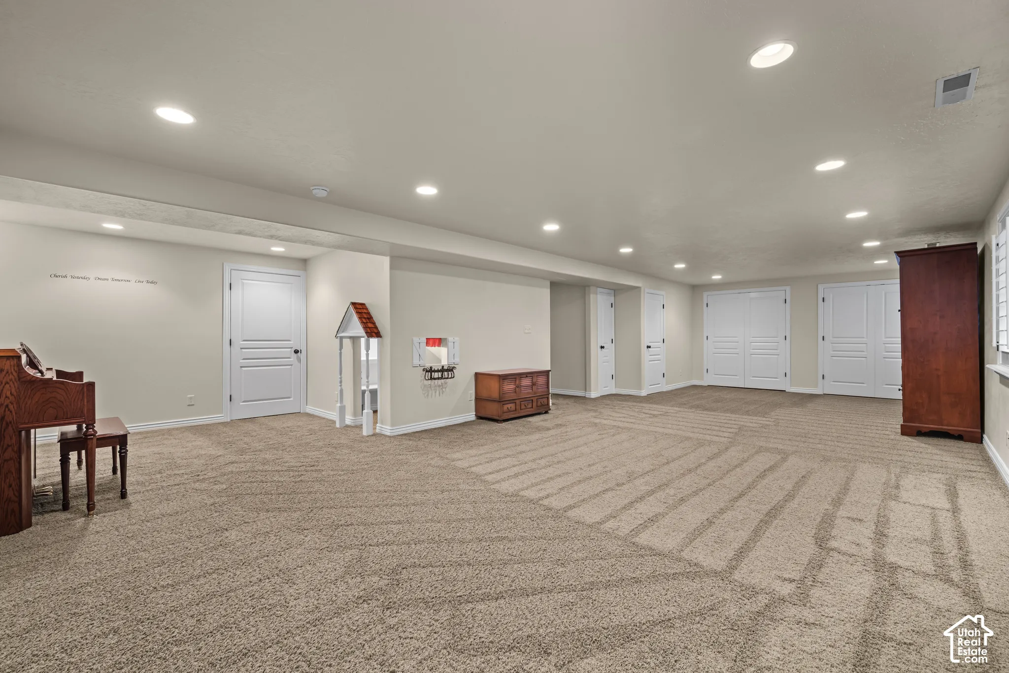 Extra large family room with lots of storage and recessed lighting.  Cute kids playhouse under the stairs