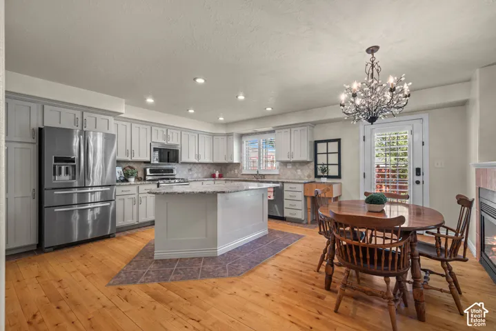 remodeled kitchen with grey shaker style cabinets and granite countertops