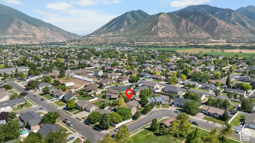 Expansive neighborhood featuring a variety of residential properties, mature trees, and mountainous surroundings