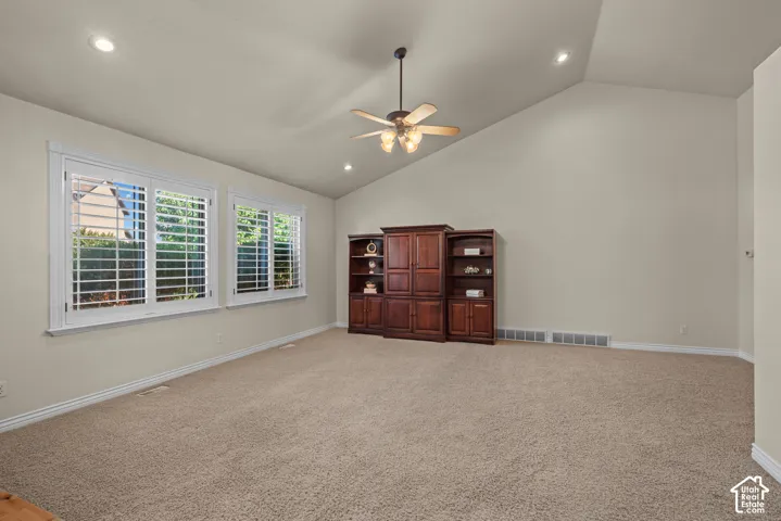 great room with vaulted ceiling, recessed lighting and plantation shutters
