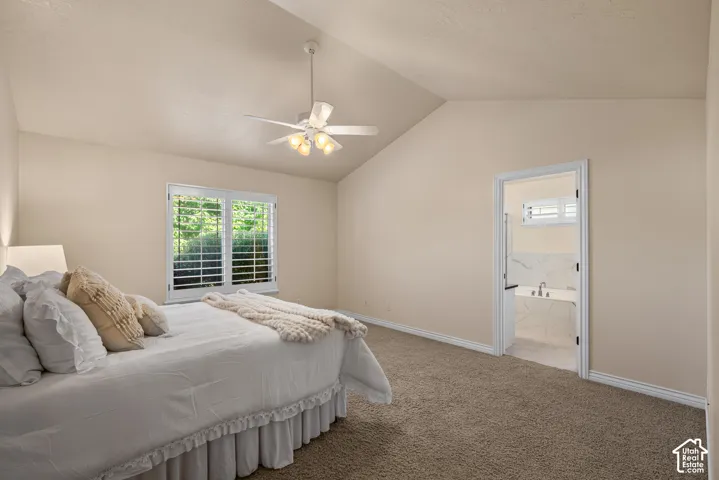 Primary Bedroom with vaulted ceiling, ceiling fan and plantation shutters