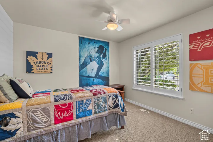Bedroom 2 with ceiling fan and plantation shutters