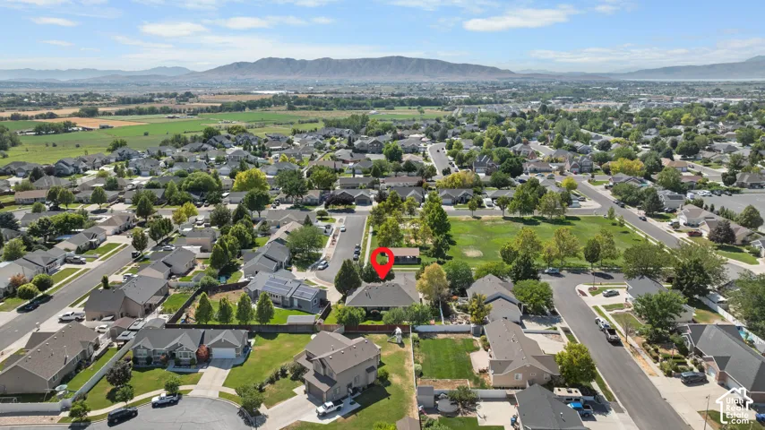 Aerial perspective showcasing a residential neighborhood with mountain scenery in the background