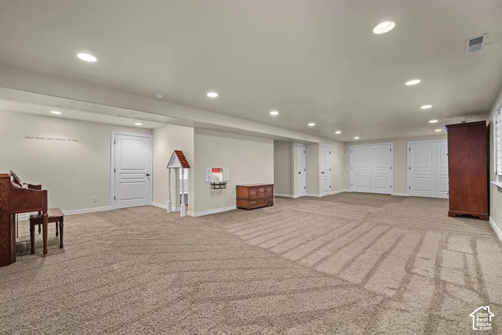 Extra large family room with lots of storage and recessed lighting.  Cute kids playhouse under the stairs
