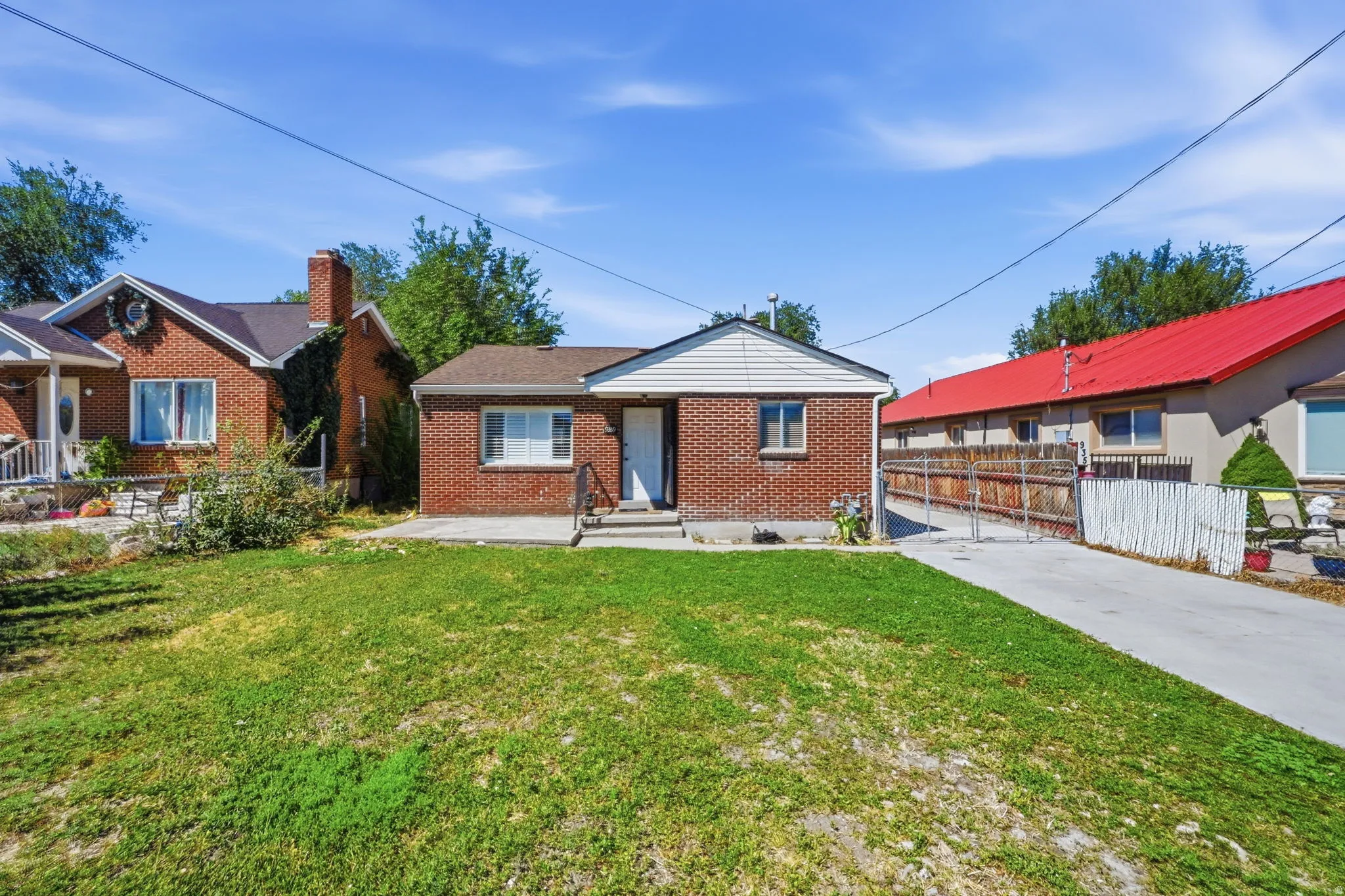 Brick exterior with white siding accents and a concrete driveway