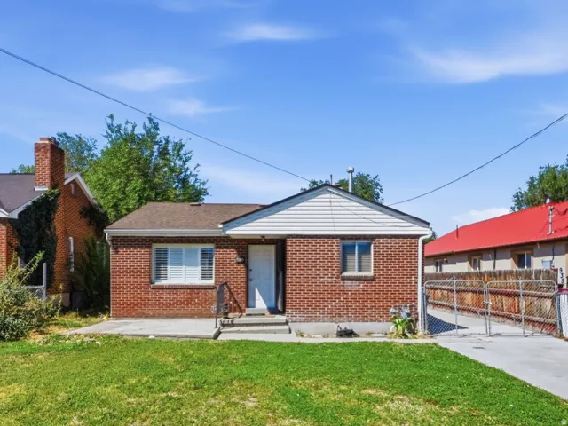 Brick exterior with white siding accents and a concrete driveway