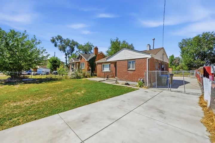 Red brick exterior with white siding accents and a pitched roof