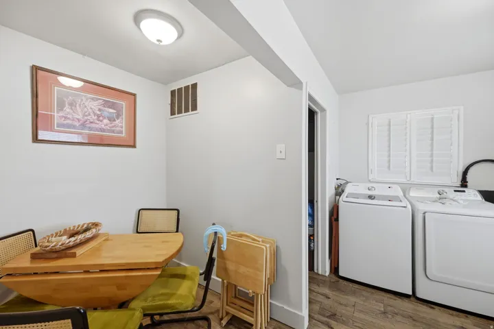 Wood-finish flooring with white walls and a ceiling light fixture