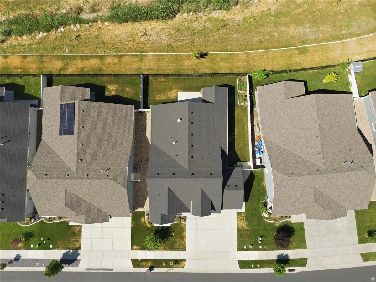 Modern residential community featuring three contemporary homes with clean architectural lines, composite or asphalt roofing, and front-facing garage entries